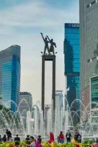 Famous statue surrounded by skyscrapers and fountain in Jakarta, Indonesia.