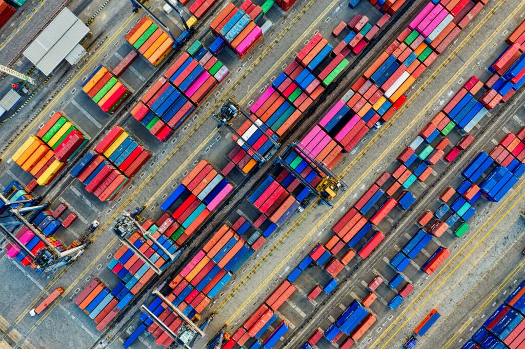 Aerial view of vibrant shipping containers at a busy Jakarta port, showcasing global trade.